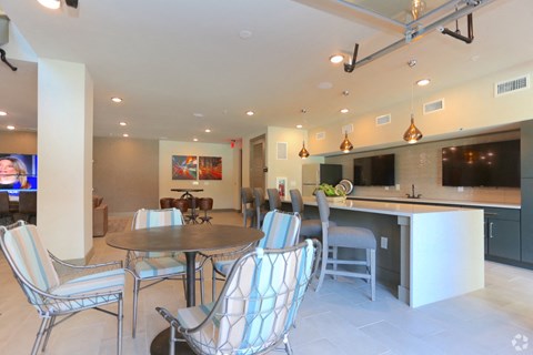 a living room and kitchen with a table and chairs